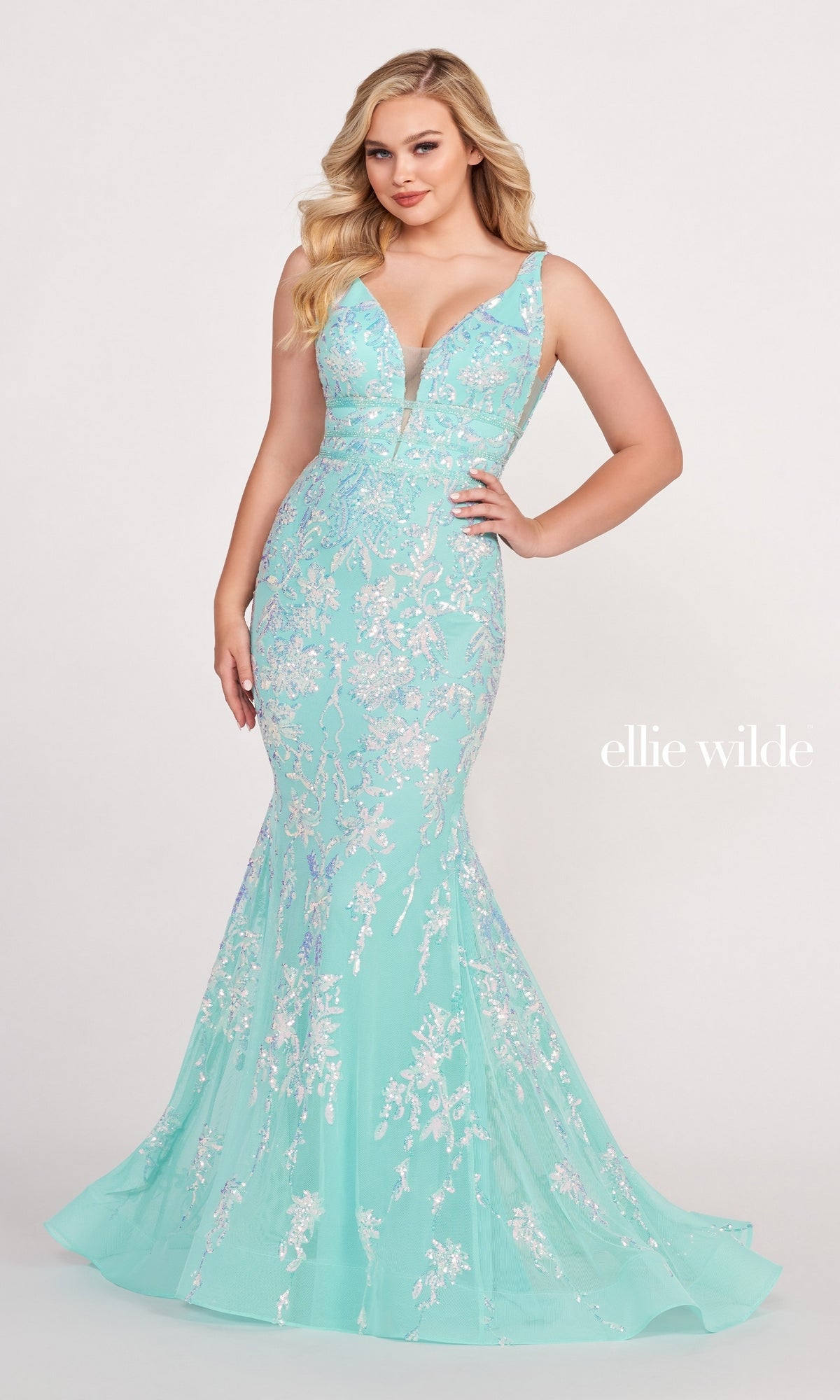 A woman wears the Banded-Waist Long Sequin Mermaid Prom Dress, featuring a light blue, floor-length mermaid silhouette with shimmering sequins and a plunging neckline, standing against a plain background.
